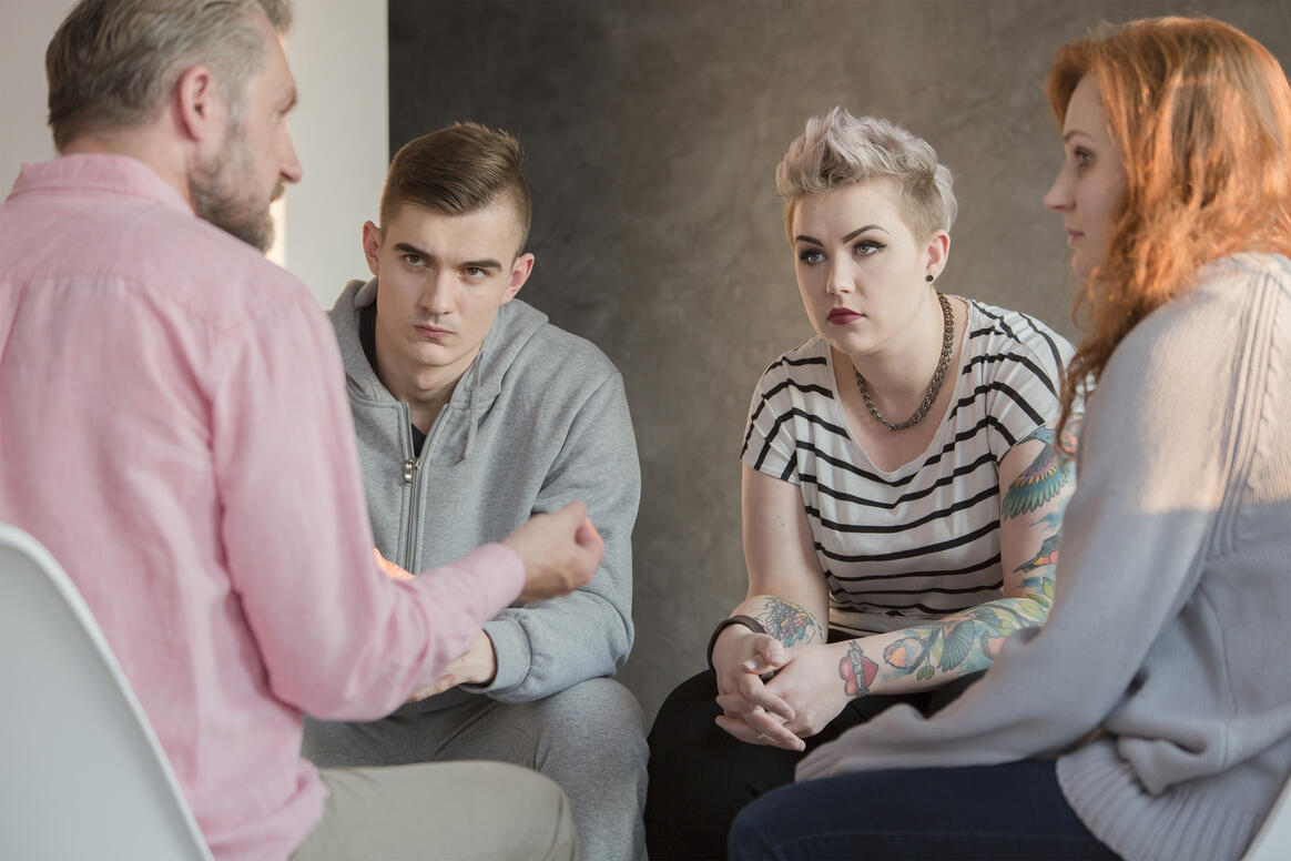Therapist talking to a group of teenagers